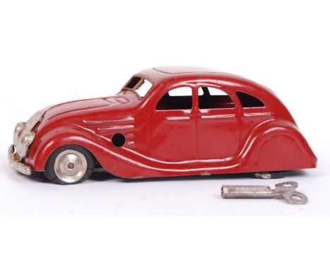 An early vintage Triang Minic clockwork tinplate ' Streamlined Saloon ' model car. In red, with original tyres. Working order