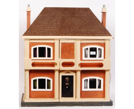 A charming vintage dolls house of 1930's style. Six rooms, with opening front section. Original decoration remains within. No