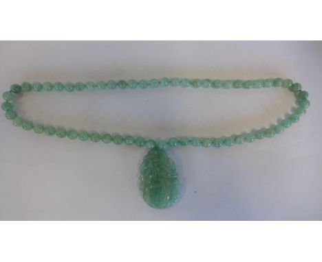 A light green jade pendant necklace, approx 64cm long, pendant 5.5cm, in generally good condition, minor usage wear 
