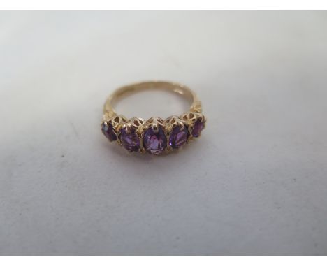 A 9ct yellow gold five stone amethyst ring, size K, approx 3.2 grams, in good condition 