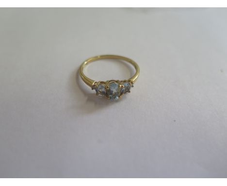 An 18ct gold diamond and blue topaz ring, size P, approx 2 grams, in good condition 