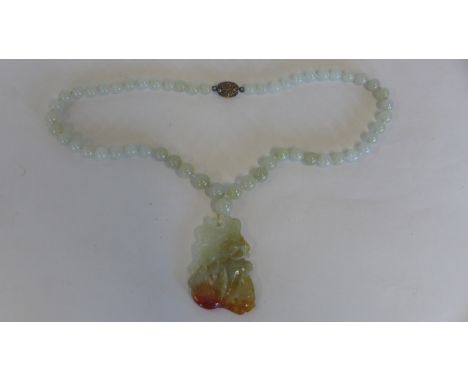 A jade necklace with a silver clasp, 48cm long, with carp in a pool pendant, in good condition 