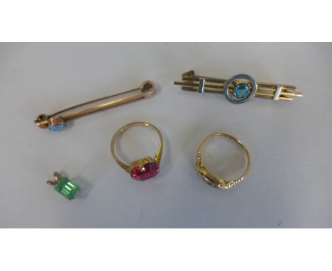 An 18ct gold ring with stone missing, approx 2.4 grams, a 9ct gold pendant, a brooch and a ring, approx 4.5 grams, and anothe