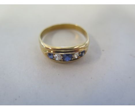 An un hallmarked gold diamond and sapphire five stone ring, size S, approx 4.7 grams, in generally good condition 