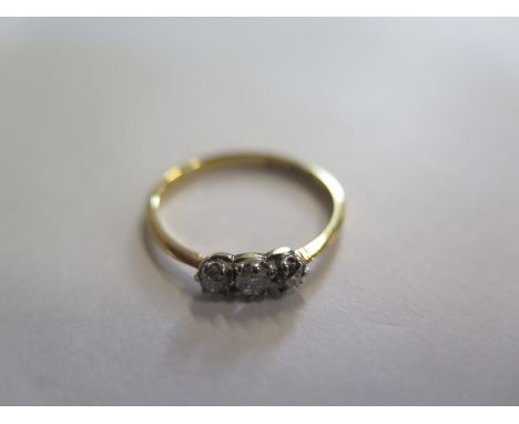 An 18ct gold three stone diamond ring, size O, approx 0.20ct, approx 2 grams, in good condition 