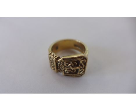 A 9ct buckle gold ring, size K, approx 6.9 grams, some usage marks but generally good 