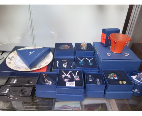A collection of eleven Swarovski glass decorative items, all with boxes, together with a Royal Worcester plate and collection