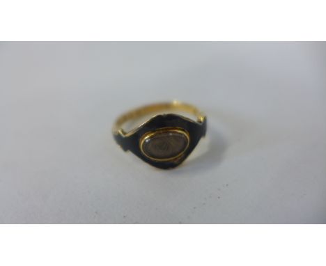 An 18ct gold Victorian mourning ring with black enamel, approx 2.9 grams, size O, some losses to enamel 