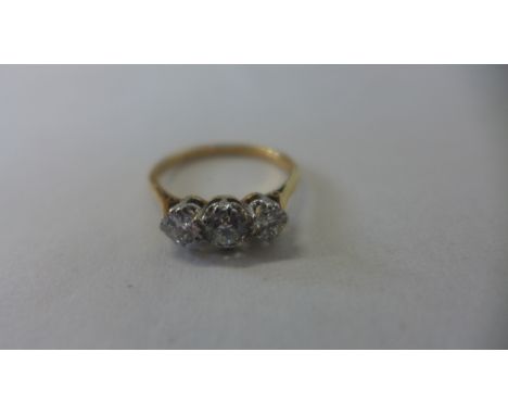 An 18ct yellow gold three stone diamond ring, size Q, approx 3.2 grams, central diamond approx 0.35ct, diamonds bright, some 