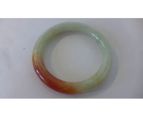 A jade bangle 7.5cm diameter, 1cm thick, internal 6.5cm, in good condition 