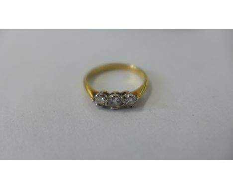 An 18ct yellow gold three stone diamond ring, size K, approx 2.4 grams, diamonds bright, some usage marks 