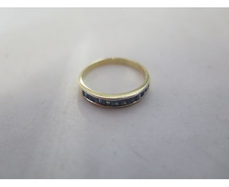 An 18ct yellow gold band ring, set with nine sapphires, ring size Q, approx 2.2 grams, in good condition 