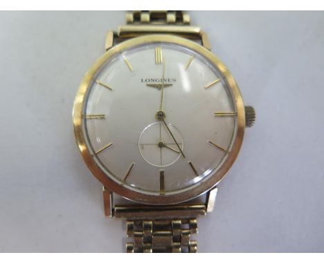 A 9ct gold gentlemens manual wind wristwatch, with baton markers, and subsidiary dial, case approx 35mm wide including button