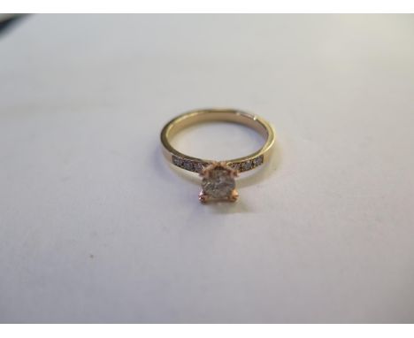 A 14ct hallmarked yellow gold diamond ring, set with a central diamond, approx 0.30ct, flanked either side by three small dia