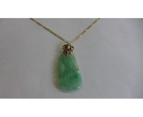 A jade pendant on a 9ct gold chain, pendant approx 5cm long, necklace approx 60cm long, chain approx 1.4 grams - in good cond