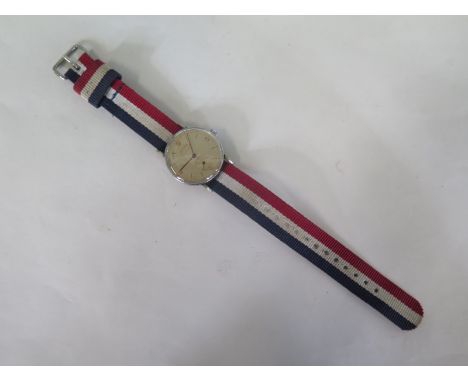 A Dogma manual wristwatch with fixed bars, ans secondary dial, 34mm wide, including button, running order 