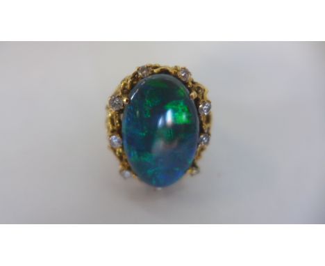 A 14ct large single black Australian opal with diamonds, cocktail ring, circa 1960's, ring size N, approx 14.6 grams, opal 22