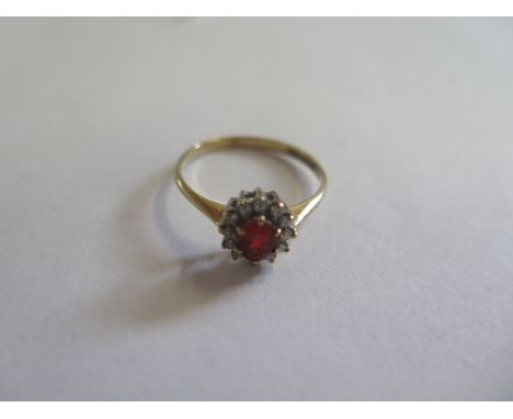 A 9ct gold diamond and orange garnet ring, approx 1.4 grams, size O, in good condition 