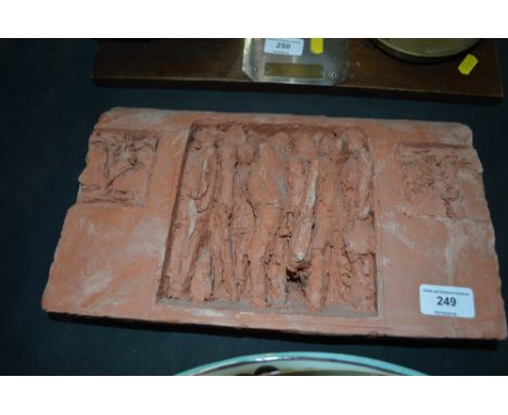 A terracotta tile decorated with figures 