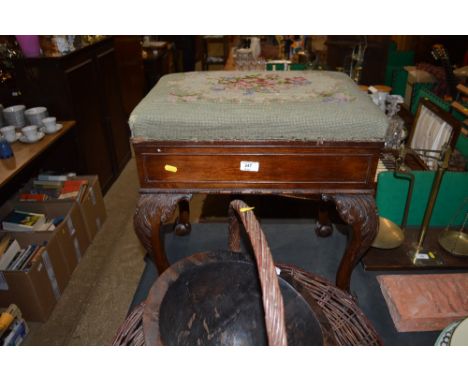 An early 20th Century mahogany piano stool raised on cabriolet supports and claw and ball feet  