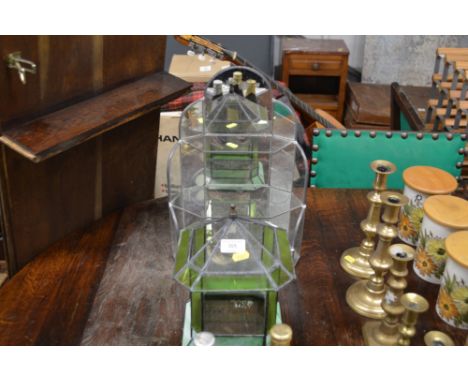 A mirrored glass three tier shelf; and a terrarium