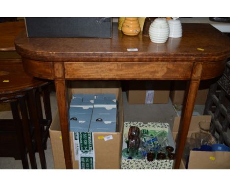 A Georgian mahogany card table raised on a square sectional supports