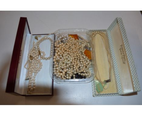Two boxes and a tray of simulated pearl necklaces 