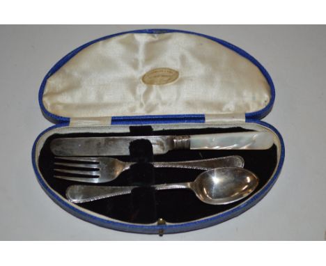 A cased three piece Christening set comprising of fork, spoon, and mother of pearl handled knife Sheffield 1951/52