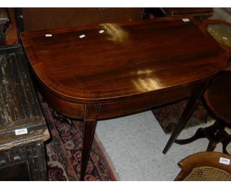 A satinwood and burr walnut cross banded card table of demi-lune form on square section tapering legs