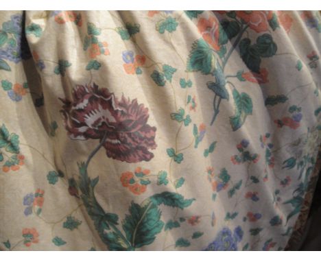 A pair of glazed cotton interlined curtains, the cream ground with floral sprays of purple poppies, blue primula and other fl