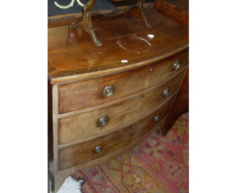 An early 19th Century mahogany bow fronted chest, the cross banded top with applied moulded edge above three long graduated d