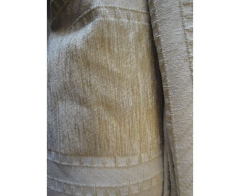 A large pair of beige ground striped lined curtains