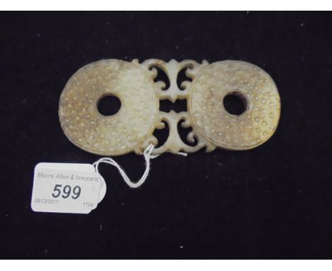 A 19th Century carved jade buckle, the two pierced disc ends with textured surface fixed between pierced decoration   CONDITI