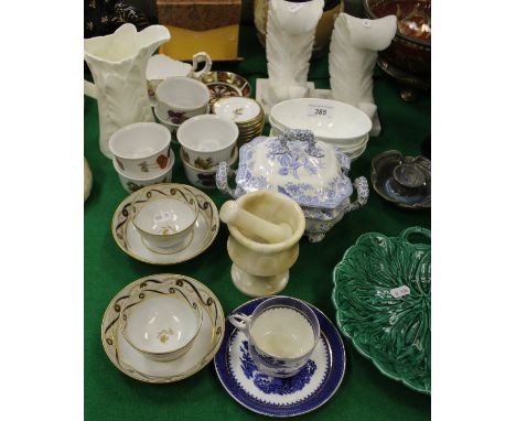 A pair of early 19th Century Worcester style blue and gilt decorated tea bowls and saucers, a Royal Worcester leaf jug, four 