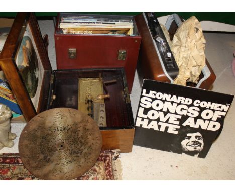 A walnut cased polyphon, together with thirty-three various discs and a box of various LP records including Bob Dylan "Nashvi