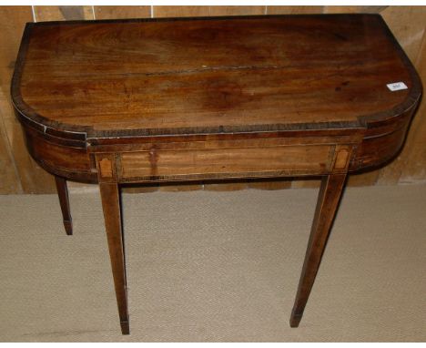 An early 19th Century mahogany and rosewood cross banded satinwood strung fold-over card table, the break front top with bowe