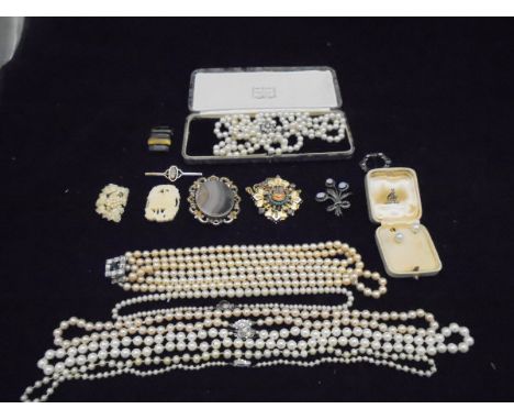 A collection of costume jewellery to include various pearl necklaces, hard stone set brooch, a 9 carat gold and opal set bar 