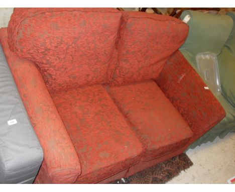 A Kirkdale red foliate upholstered two seat sofa