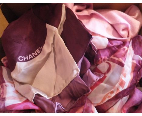 A box containing a Gucci pale pink scarf, a Dior silk scarf, a Gucci floral decorated silk scarf, another similar, a Gucci sc