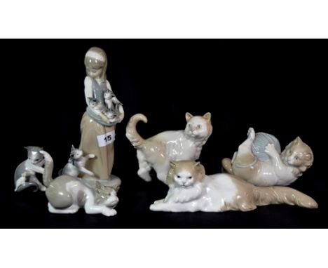 A Lladro figure of a girl with kittens and five Nao and Lladro cat figures.