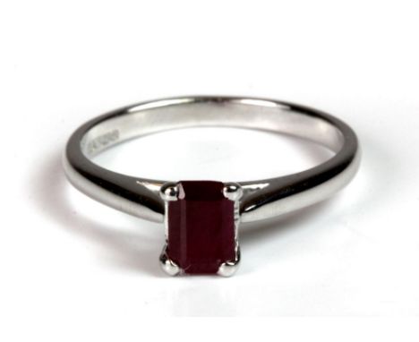 A 9ct white gold ring set with an emerald cut ruby, (N).