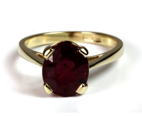 A 9ct gold ring set with an oval cut dark red ruby (4ct), (N).