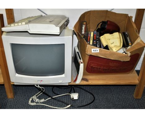 A vintage Amstrad 464+ games console and a quantity of games.