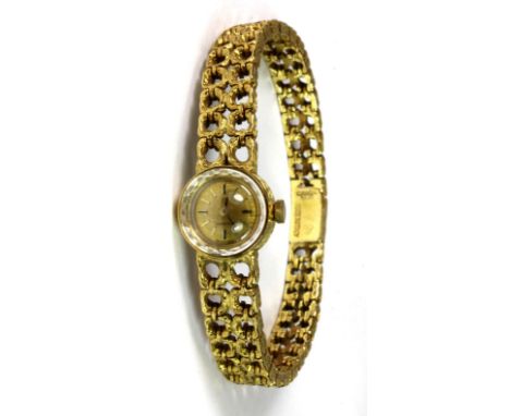 An 18ct lady's 1960's Omega wrist watch with integral strap and original box.