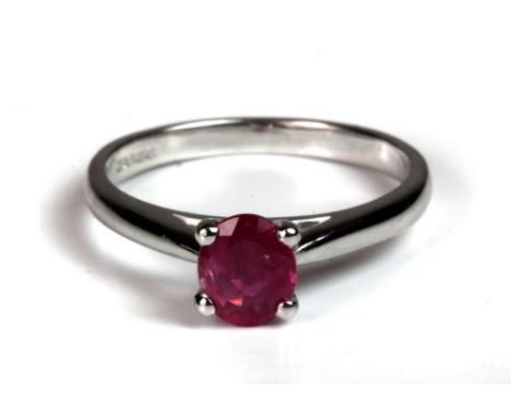 A 9ct white gold ring set with a light red oval ruby (0.85ct), (N).