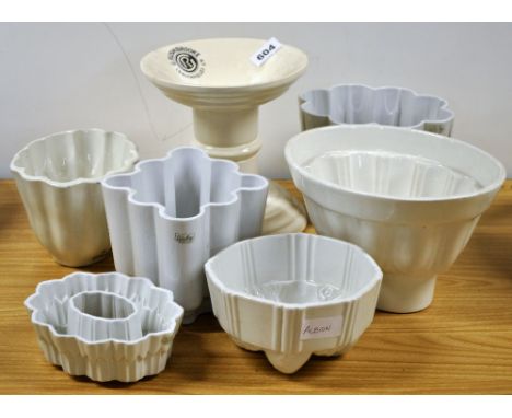 Six ceramic jelly moulds including Shelley and a ham stand.
