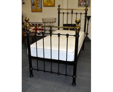 A reproduction brass and cast iron single bed.