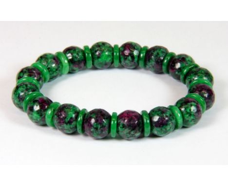 A faceted green and red ruby bead bracelet.