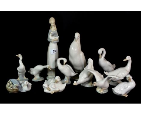 A Nao figure of a girl with a duck and a quantity of Nao and Lladro duck figures with one pigeon.