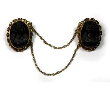 A Victorian silver gilt and jet cloak brooch.